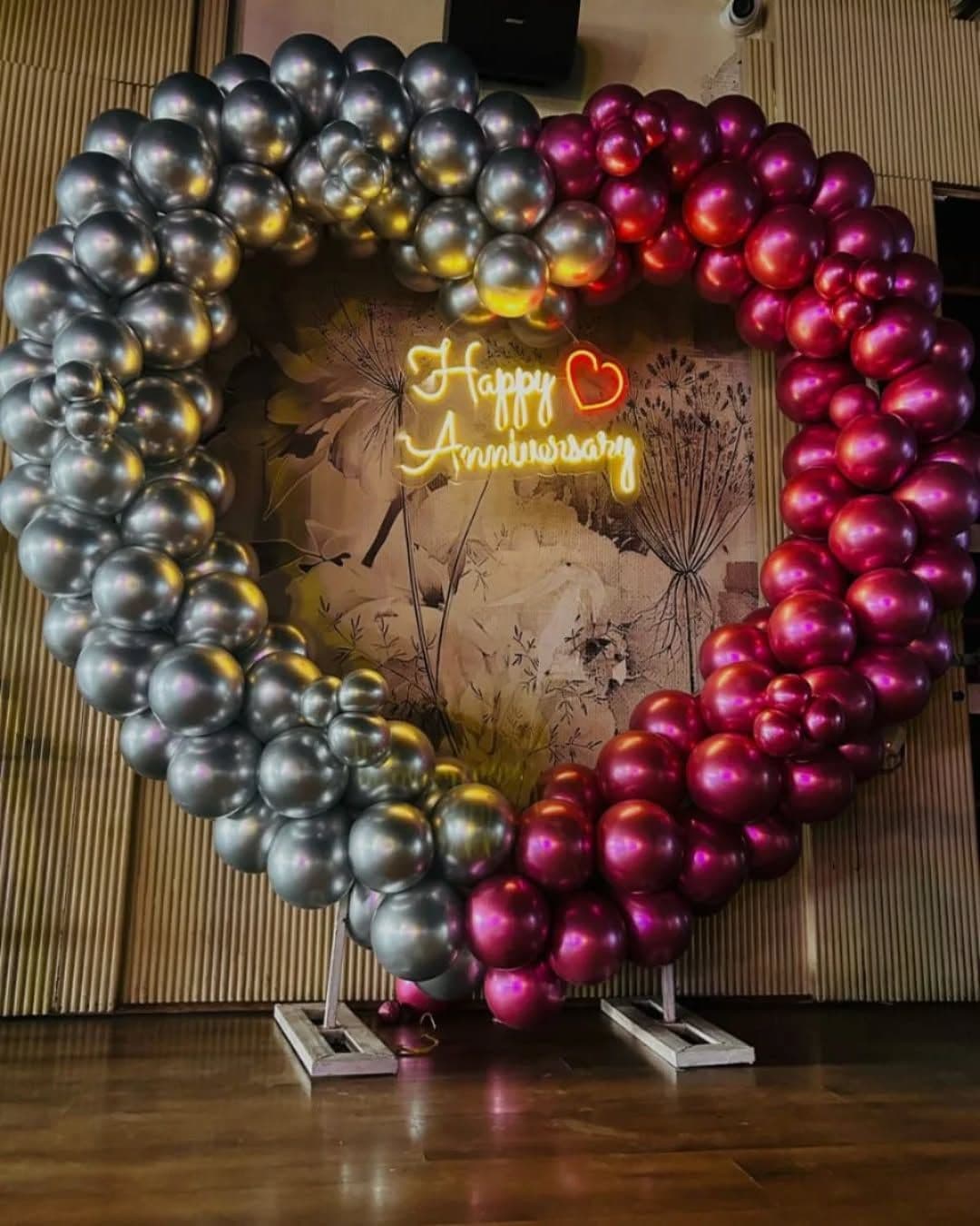 Happy Anniversary Heart Balloon Decor With Neon Sign And Floral Mural Backdrop
