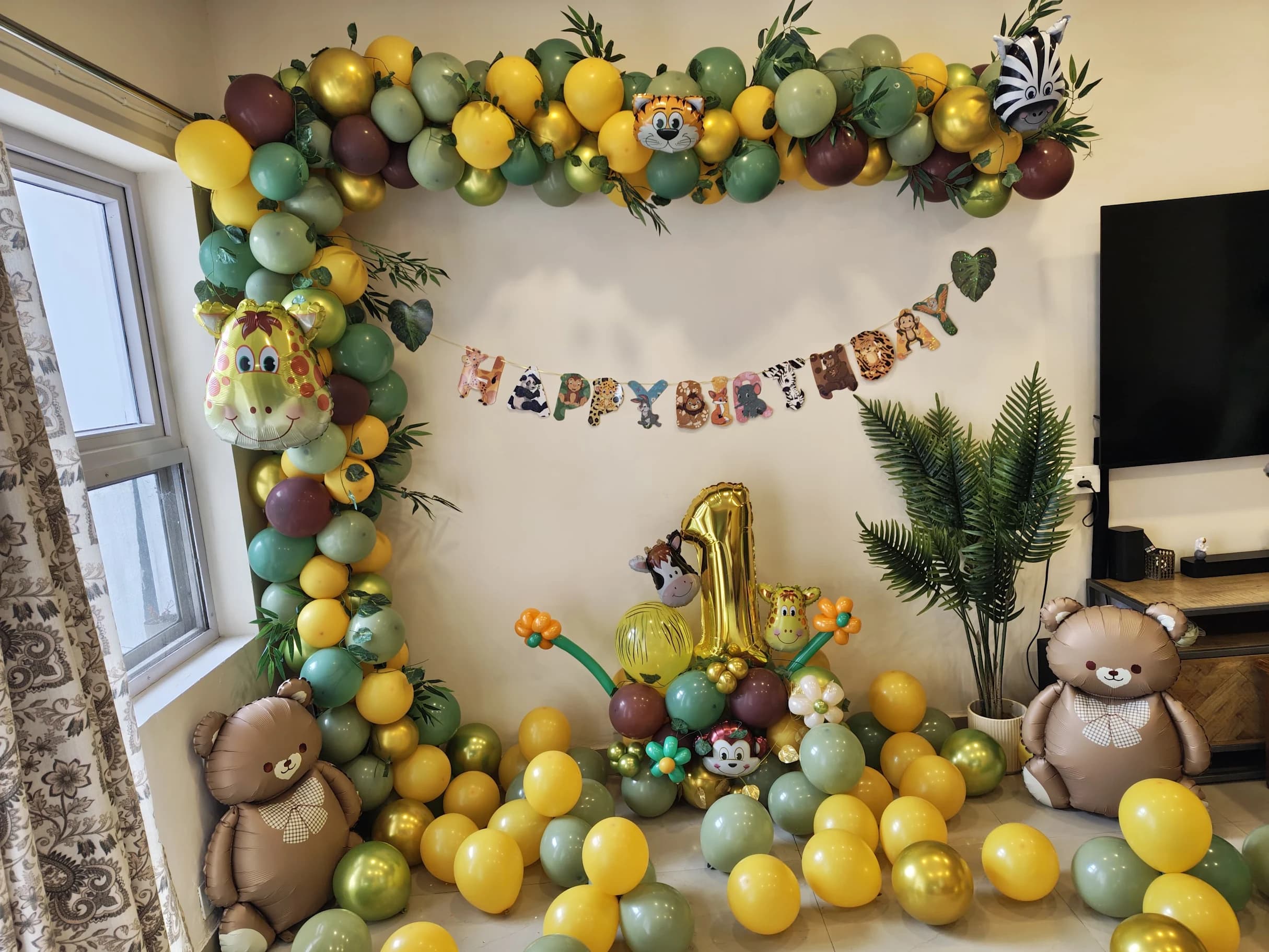 Happy Birthday Jungle Safari Balloon Decor With Green Yellow Garland And Animal Theme setup in Faridabad
