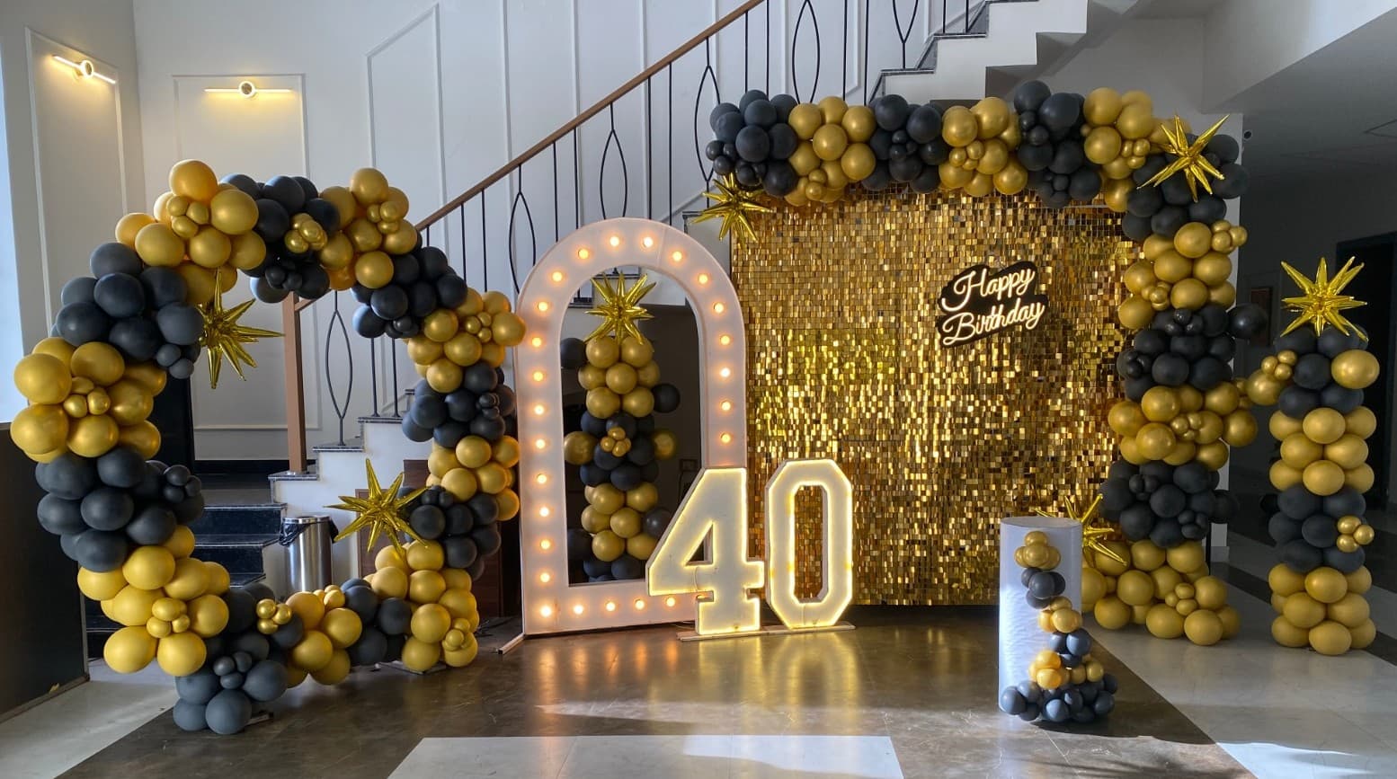 Happy Birthday Black And Gold Balloon Decor With Illuminated Number And Shimmering Backdrop