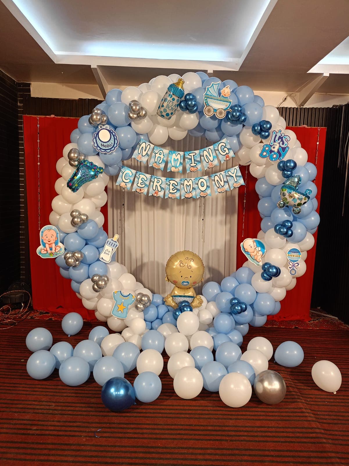 Naming Ceremony Balloon Decor With Baby Props And Red Curtain Backdrop
