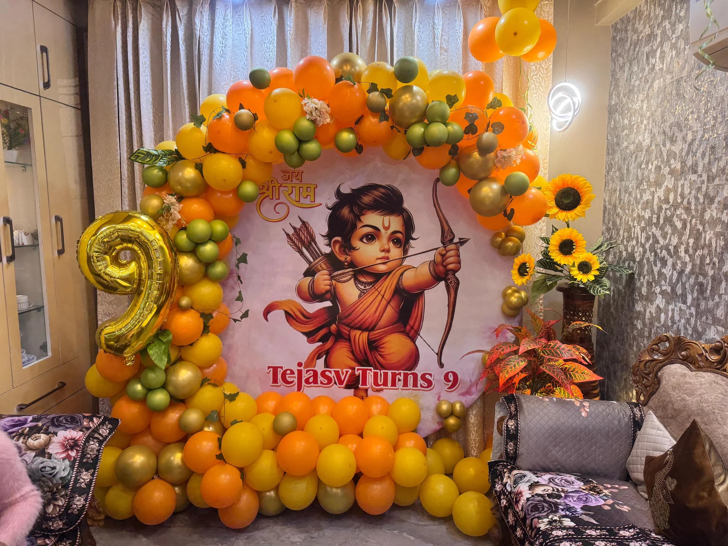 Tejasv 9th Birthday Lord Ram Theme Balloon Decor With Orange Yellow Arch And Floral Setup setup in Faridabad
