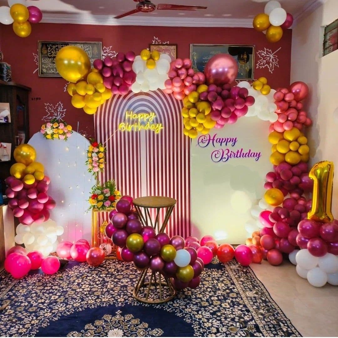 Colorful First Birthday Balloon Decor With Striped Panels And Neon Sign