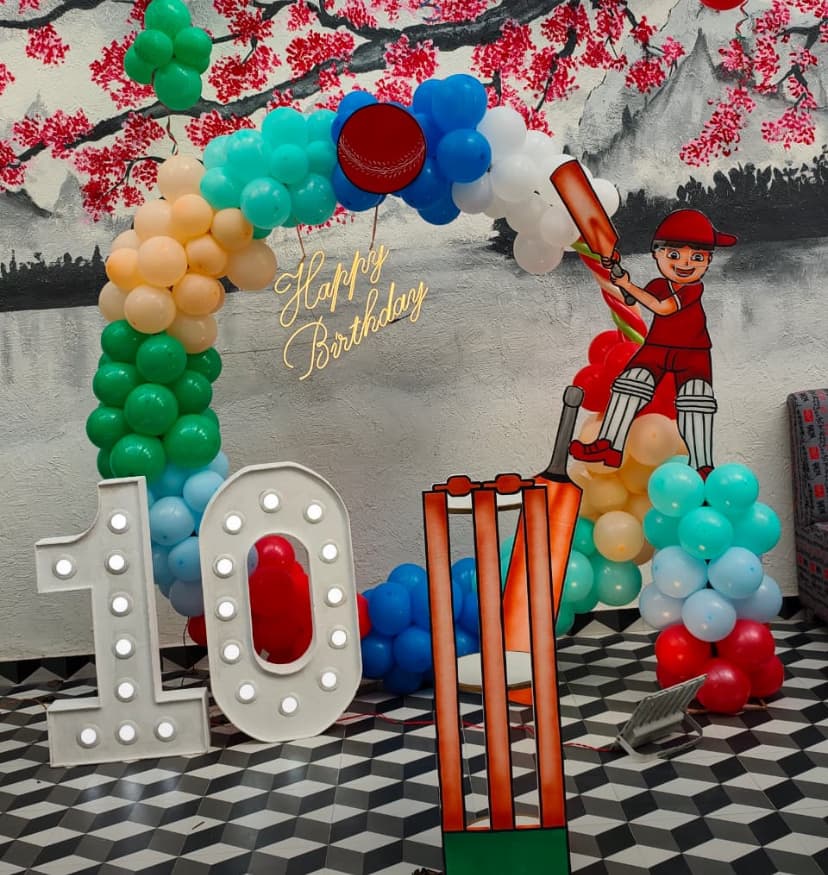 Cricket Theme Tenth Birthday Balloon Decor With Cartoon Batsman